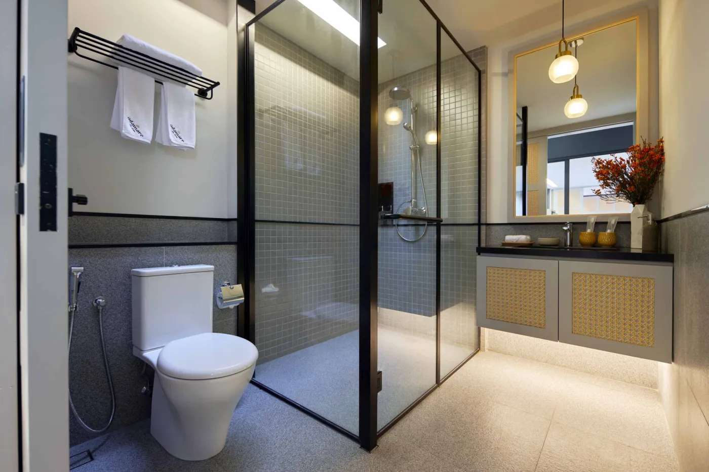 Modern open-plan room with blue mosaic tiled kitchen island, bar stools, blue sofa, bed, and large windows overlooking tropical garden. - Bali Villas