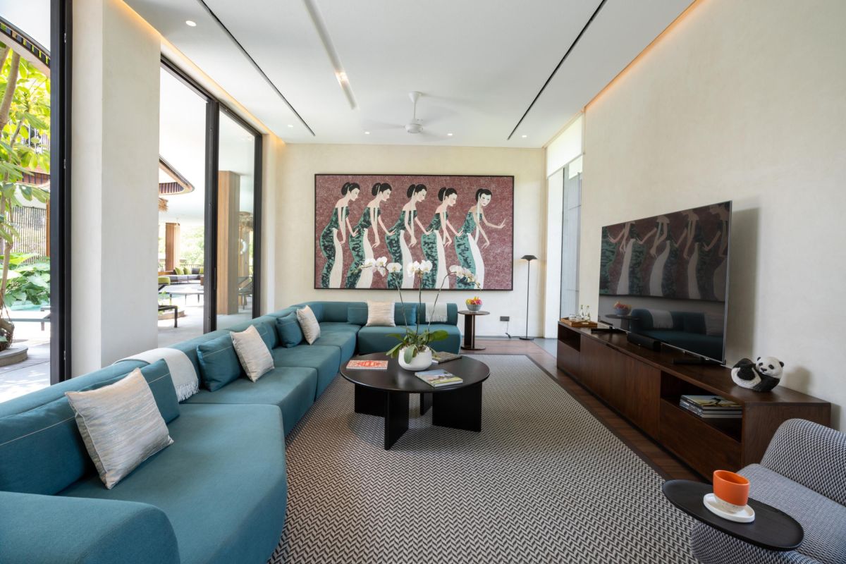 Modern luxury bathroom with freestanding white bathtub, gray stone walls, glass shower, and minimalist vanity. - Bali Villas