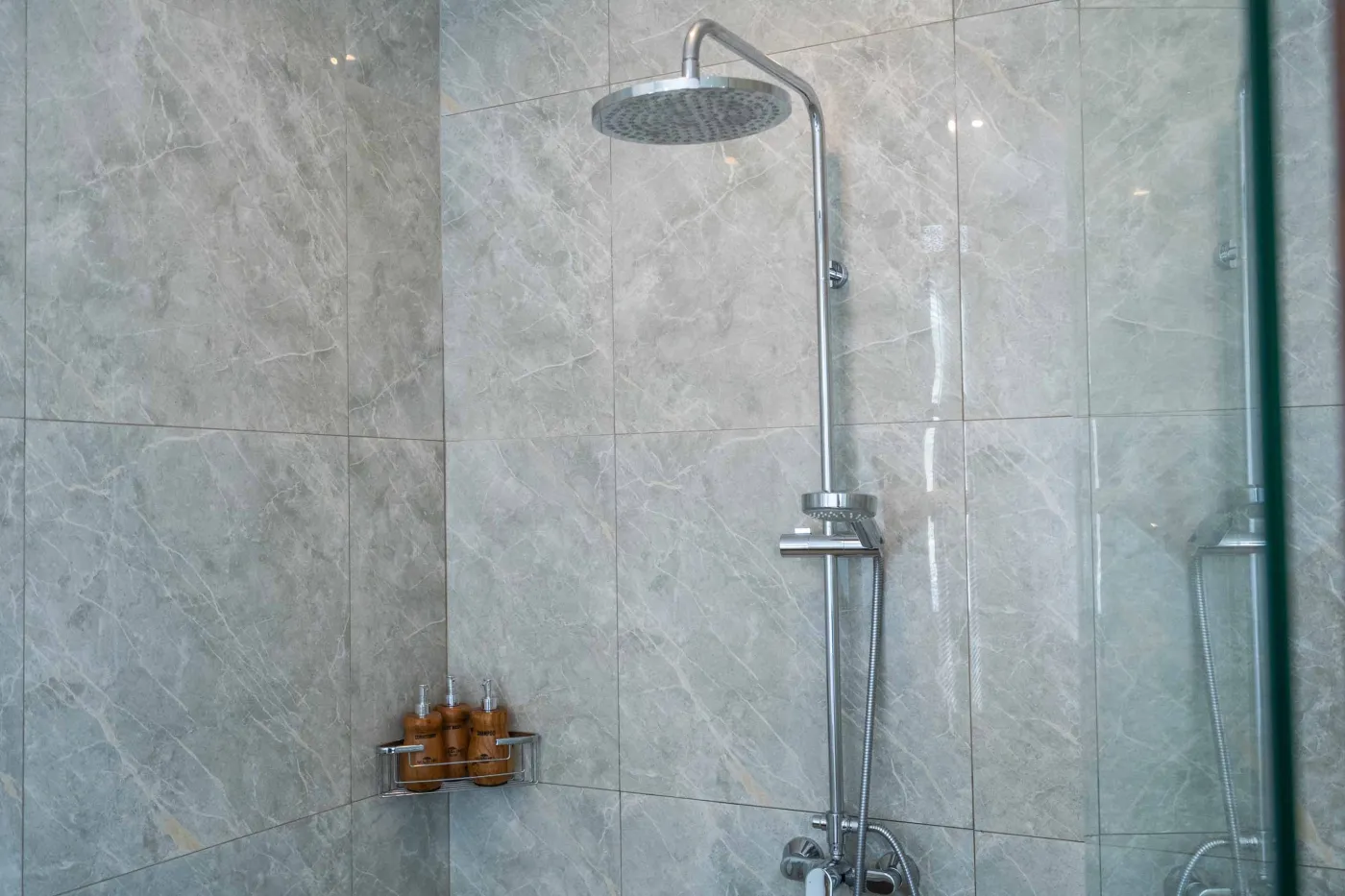 Blue and white striped towels rolled on a teal poolside lounger at a tropical resort villa. - Bali Villas