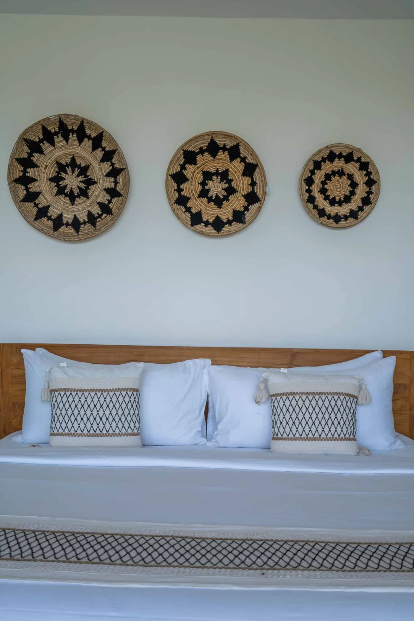 Blue and white striped towels rolled on a teal poolside lounger at a tropical resort villa. - Bali Villas