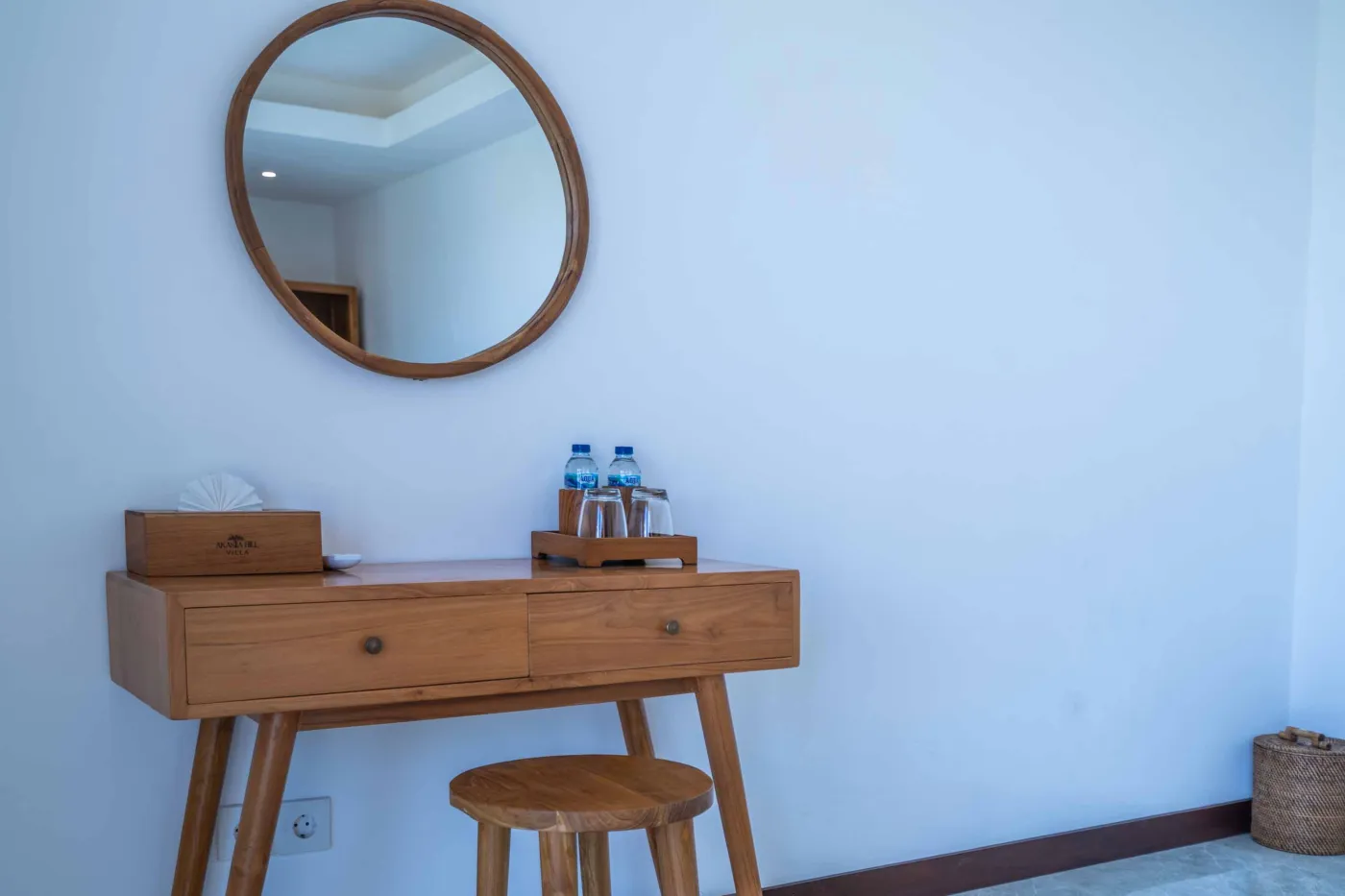 Blue and white striped towels rolled on a teal poolside lounger at a tropical resort villa. - Bali Villas