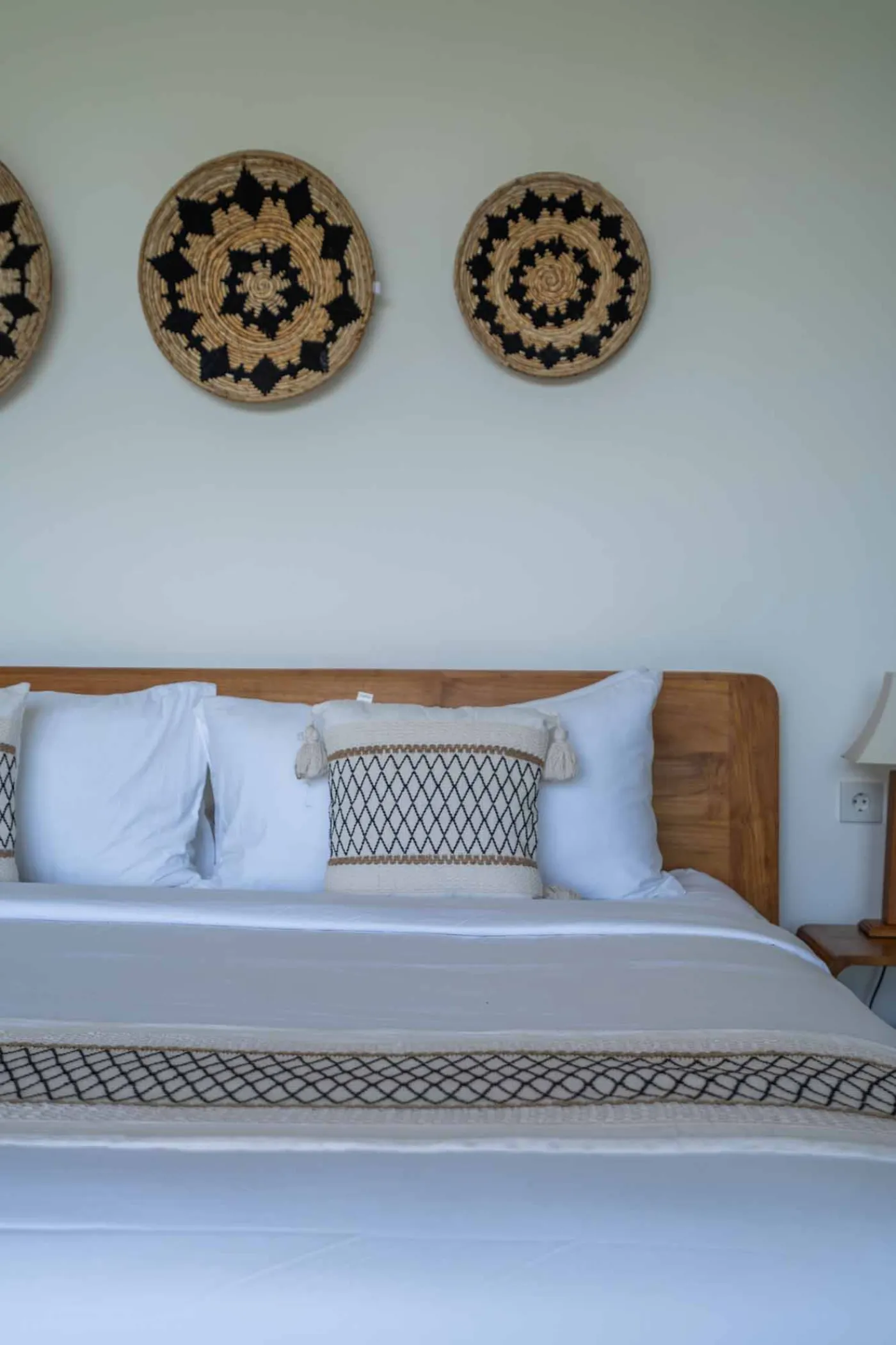Blue and white striped towels rolled on a teal poolside lounger at a tropical resort villa. - Bali Villas