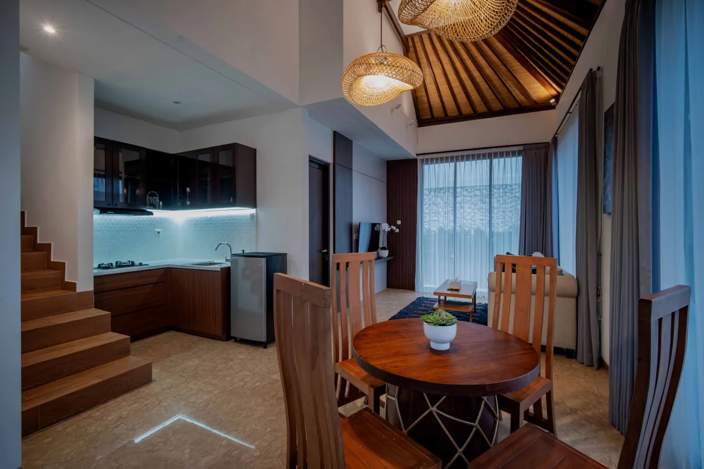 Modern hotel bathroom with double vanity sinks, large framed mirror, and frosted glass shower enclosure. - Bali Villas