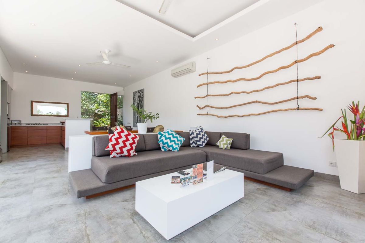 Modern luxury bathroom with wooden double vanity, white marble countertop, orchids, and folded towels. - Bali Villas