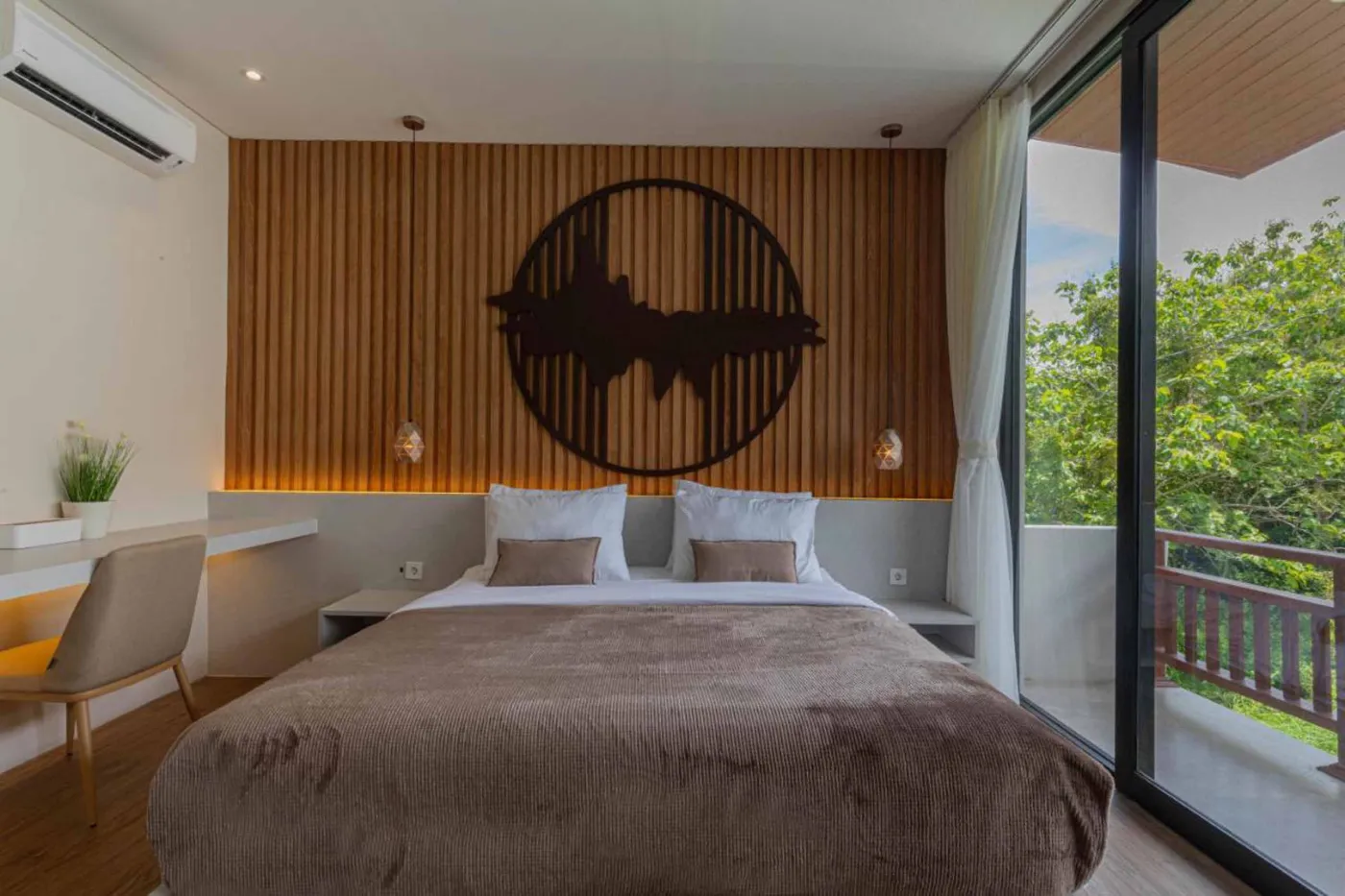 Modern minimalist kitchen with wooden cabinets, white orchids on a central table, fridge, and sink. - Bali Villas