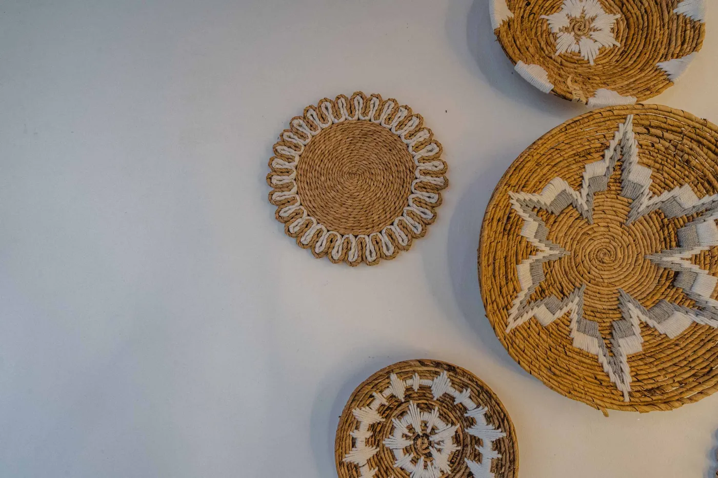 Balinese kitchen with wooden cabinets, checkered tiled backsplash, and dining table overlooking a private pool. - Bali Villas