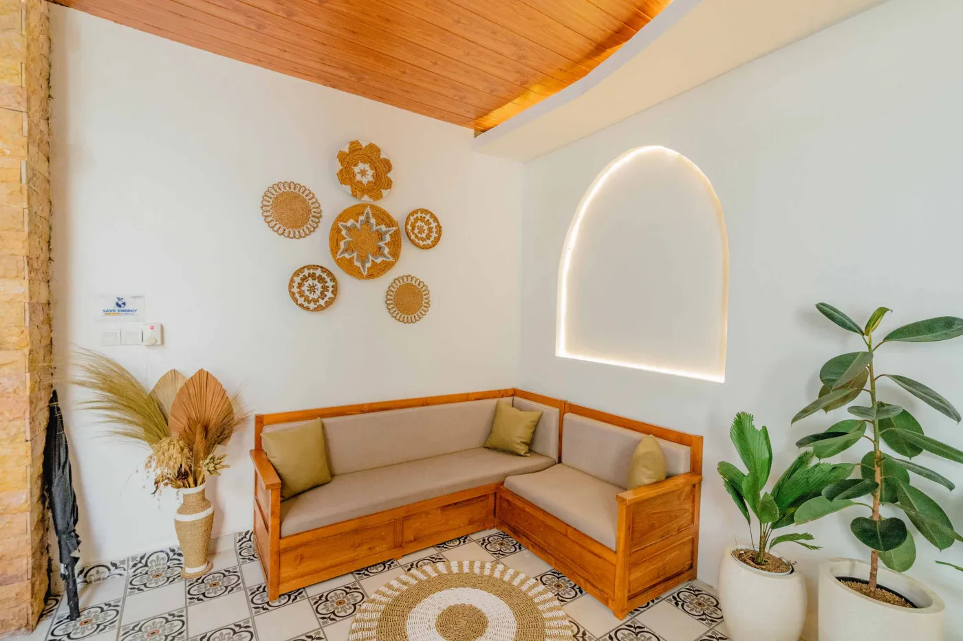 Balinese kitchen with wooden cabinets, checkered tiled backsplash, and dining table overlooking a private pool. - Bali Villas