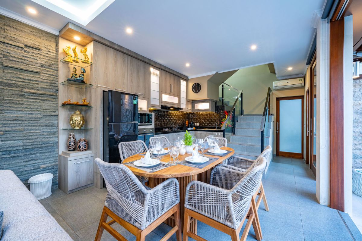 Spacious Balinese terrace pavilion with white rattan sofa, blue cushions, coffee table, and ocean horizon view. - Bali Villas