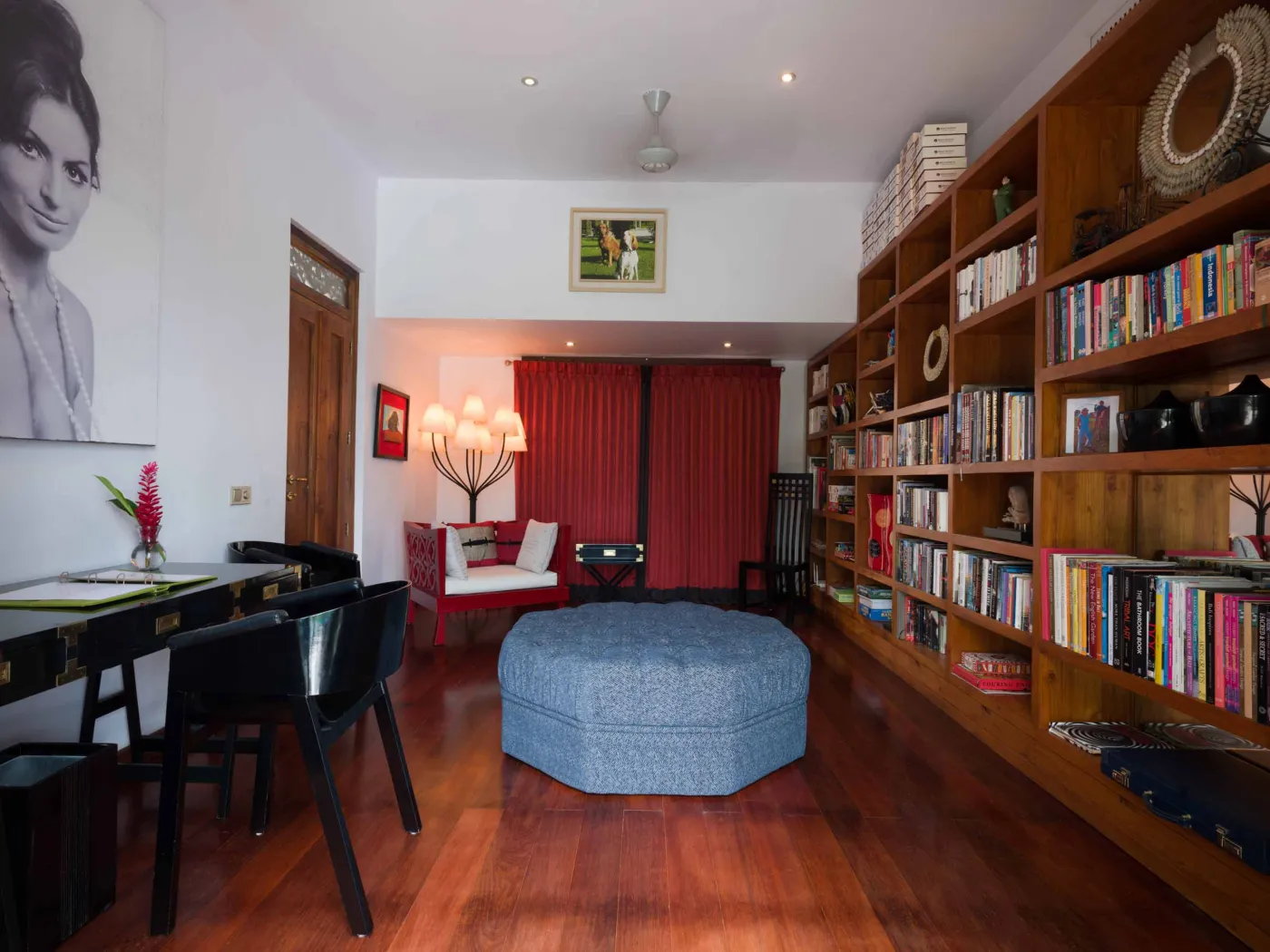 Curved stone terrace with white cushioned lounge overlooking Bali beach, ocean, and tropical gardens. - Bali Villas