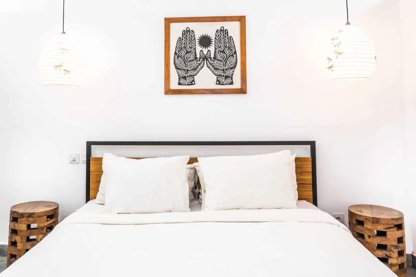 Cozy modern living room with green velvet sofa, wooden coffee table, potted plant, and adjacent white kitchen. - Bali Villas