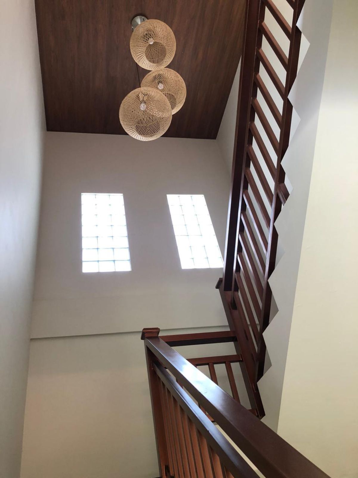 Serene tropical bathroom with stone sink, freestanding white bathtub, and lush green plants. - Bali Villas