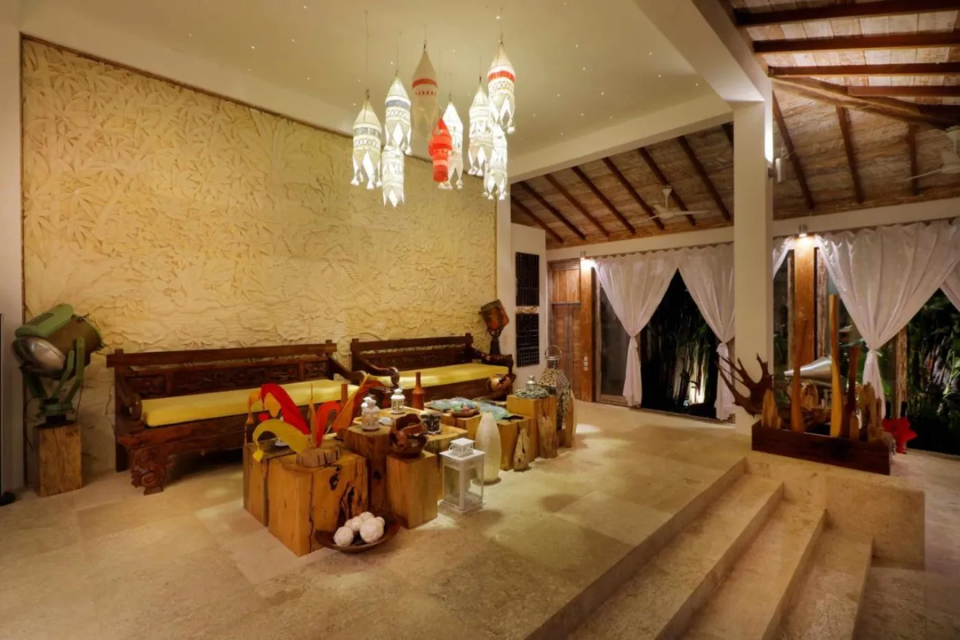 Modern luxury bathroom featuring a frosted glass block window, wooden accent wall with rain showerhead, and fresh flowers on a side table. - Bali Villas