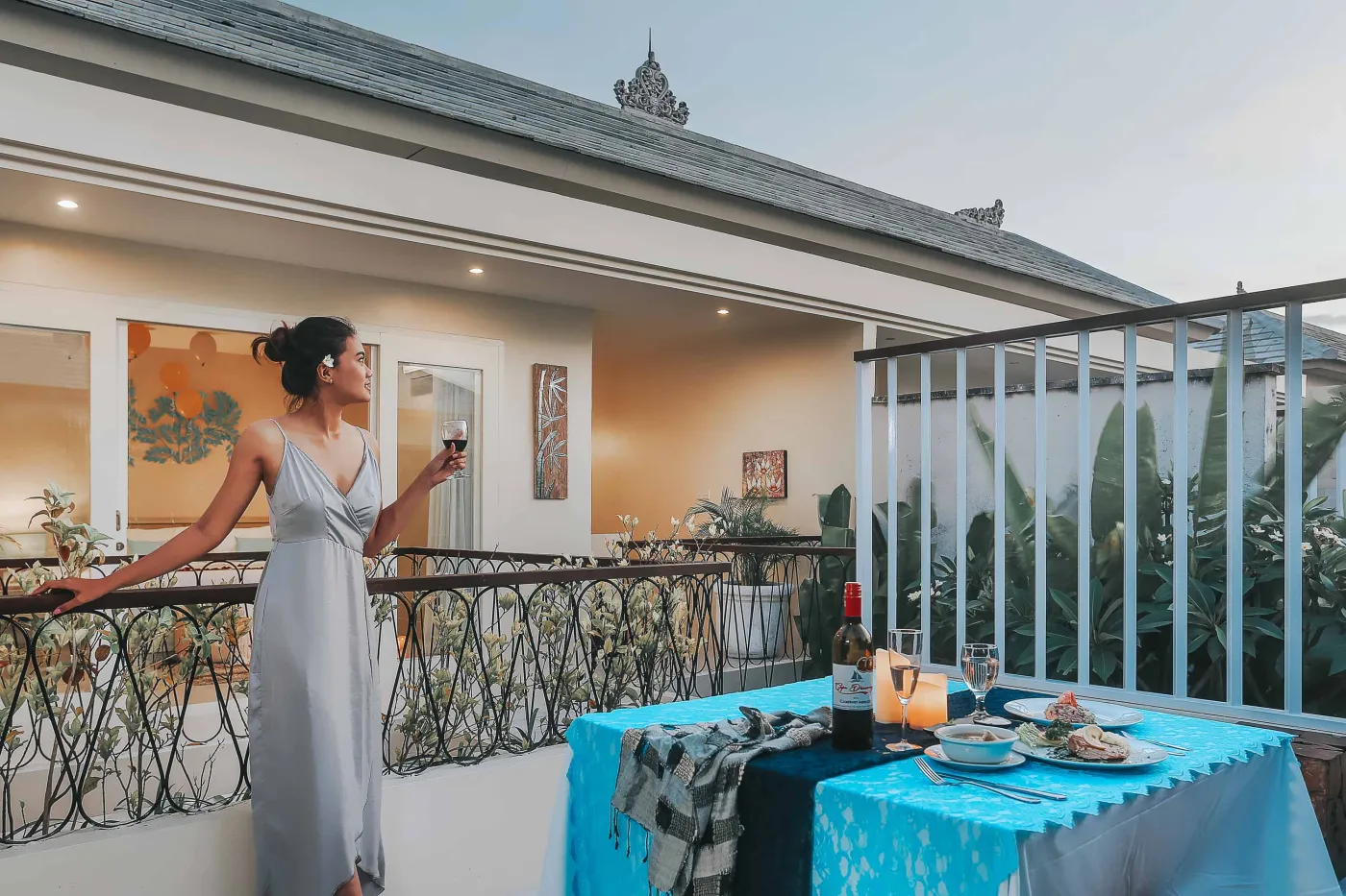 Serene private infinity pool in a modern Balinese villa courtyard, with white lounge chairs, tiled table, and tropical stone decor. - Bali Villas