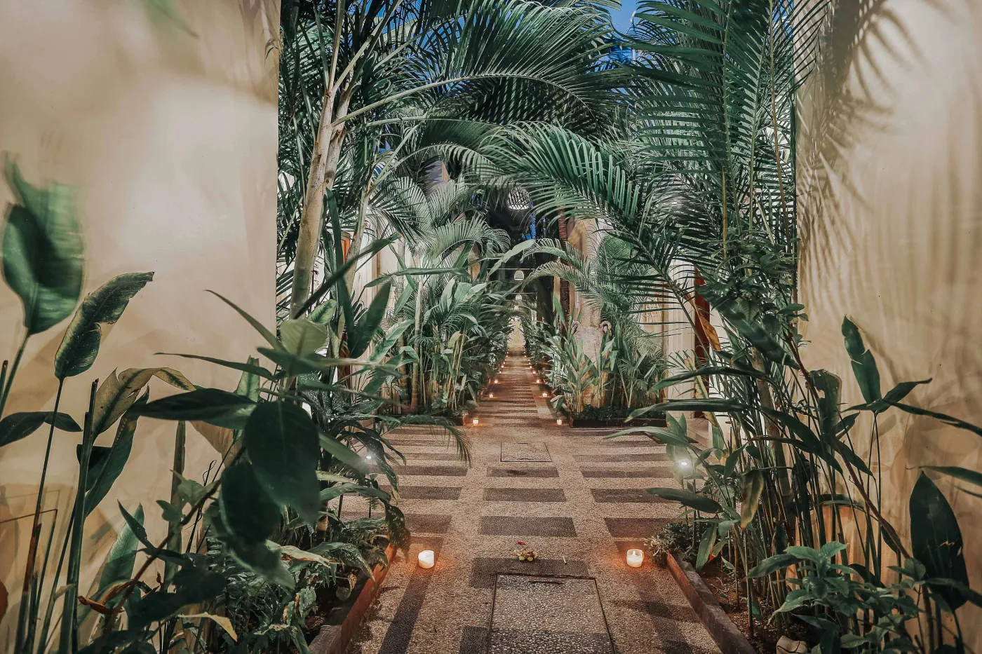 Serene private infinity pool in a modern Balinese villa courtyard, with white lounge chairs, tiled table, and tropical stone decor. - Bali Villas