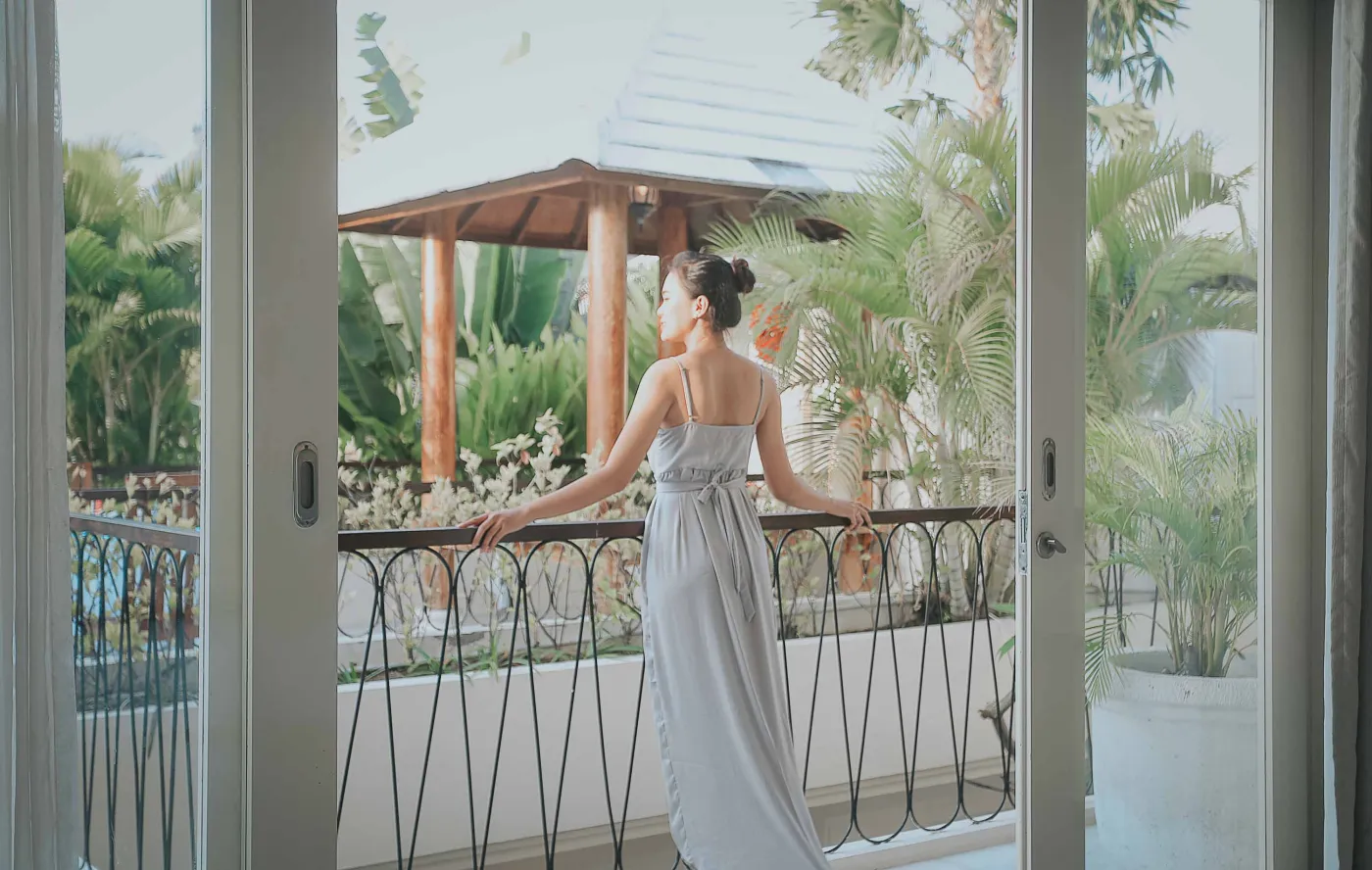 Serene private infinity pool in a modern Balinese villa courtyard, with white lounge chairs, tiled table, and tropical stone decor. - Bali Villas