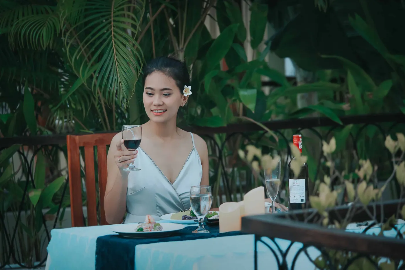 Serene private infinity pool in a modern Balinese villa courtyard, with white lounge chairs, tiled table, and tropical stone decor. - Bali Villas