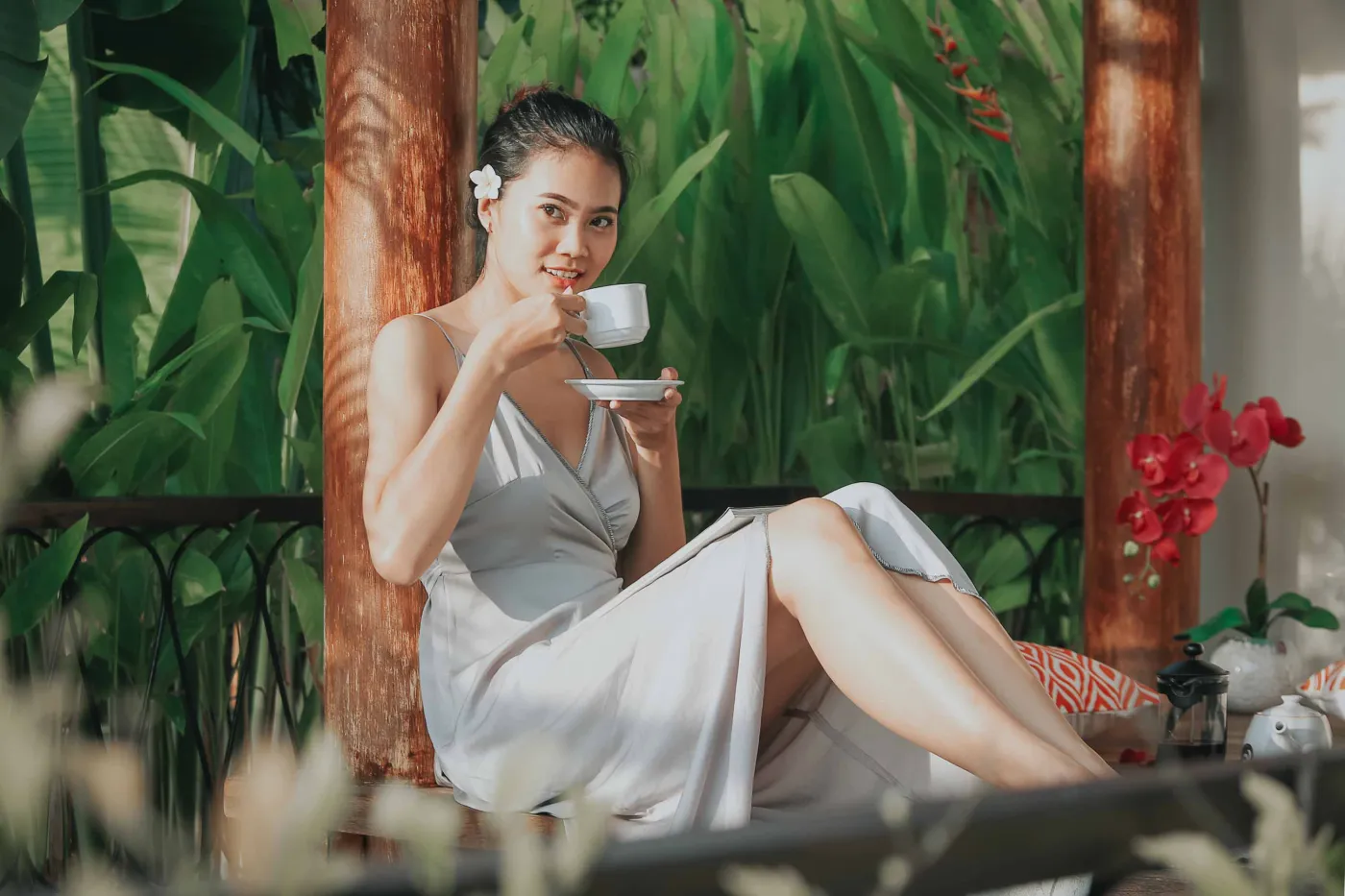 Serene private infinity pool in a modern Balinese villa courtyard, with white lounge chairs, tiled table, and tropical stone decor. - Bali Villas