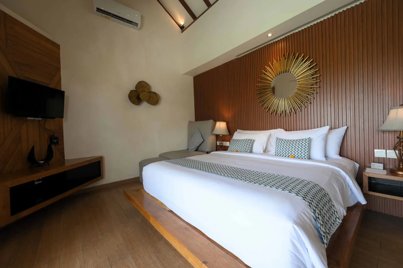 Modern luxury bathroom with freestanding white bathtub, glass shower enclosure, and floor-to-ceiling window overlooking tropical palm trees, pool, and villas. - Bali Villas