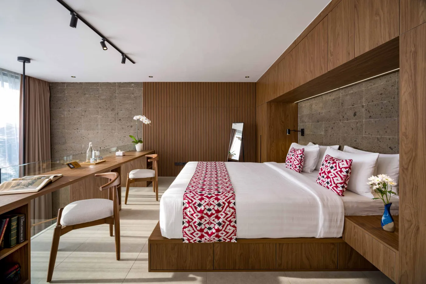 Serene private infinity pool in a tropical Bali villa, surrounded by lush palms, bean bag seating, and modern stone walls. - Bali Villas