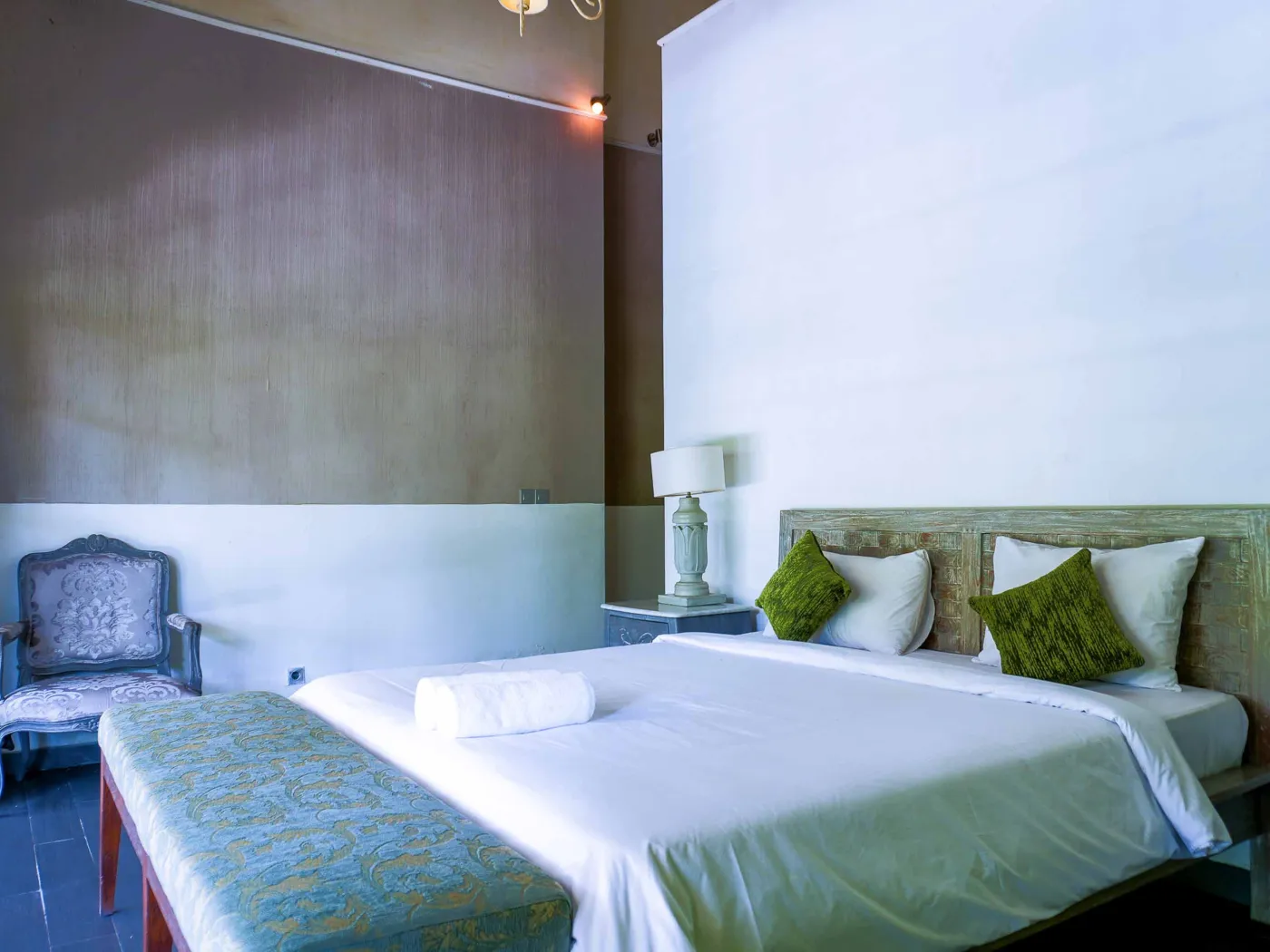 Spacious tropical villa interior with open wooden architecture, modern kitchen, cozy seating area, and lush garden view. - Bali Villas