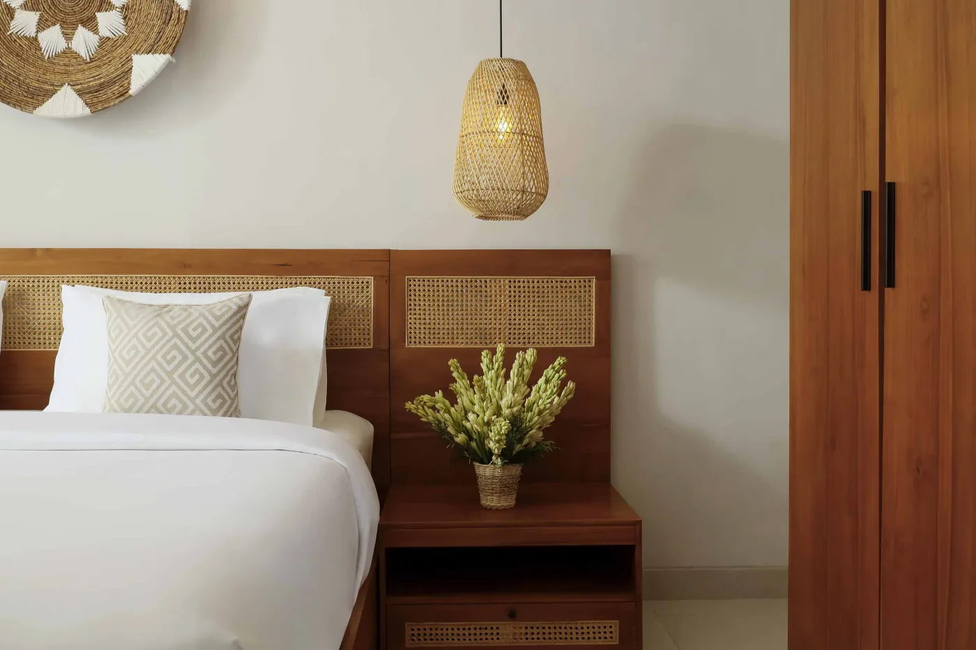 Modern open-plan kitchen and dining area with wooden furniture, tropical plants, and Balinese-style decor. - Bali Villas