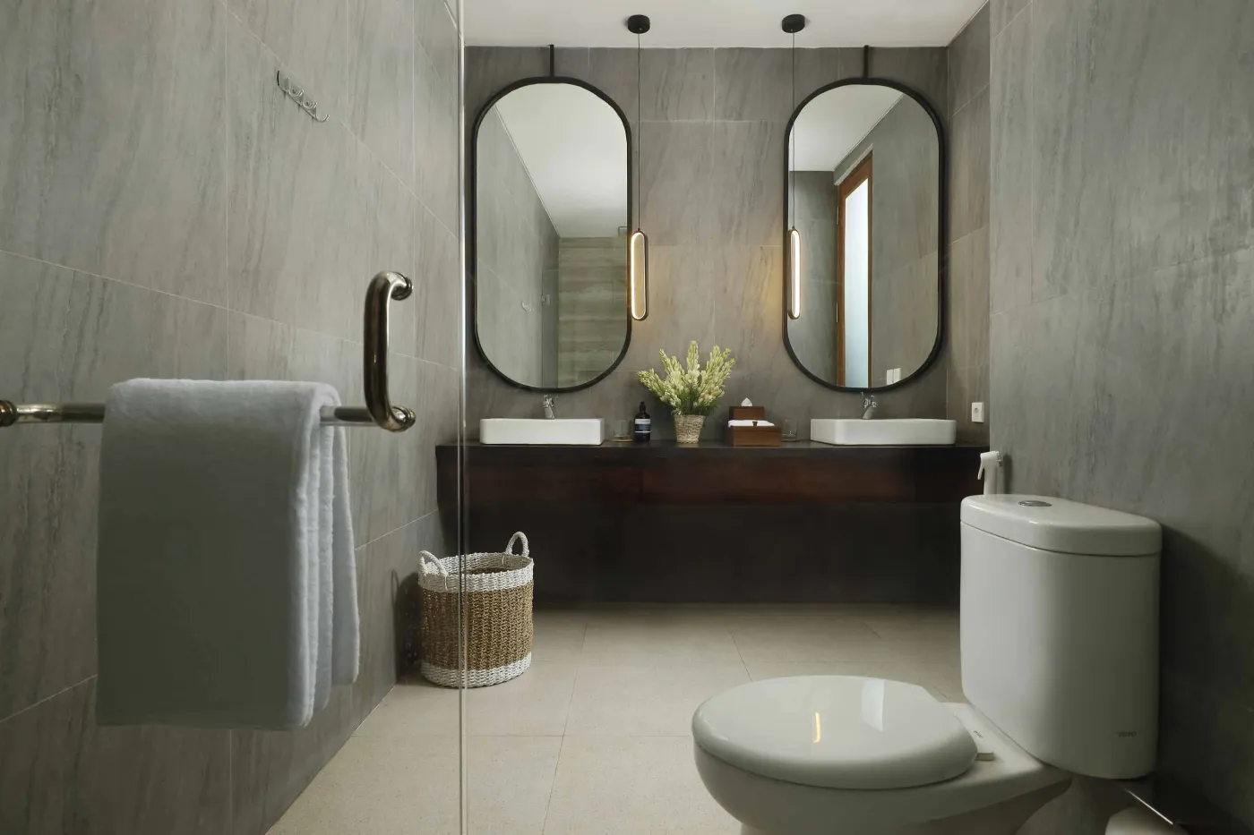 Modern open-plan kitchen and dining area with wooden furniture, tropical plants, and Balinese-style decor. - Bali Villas