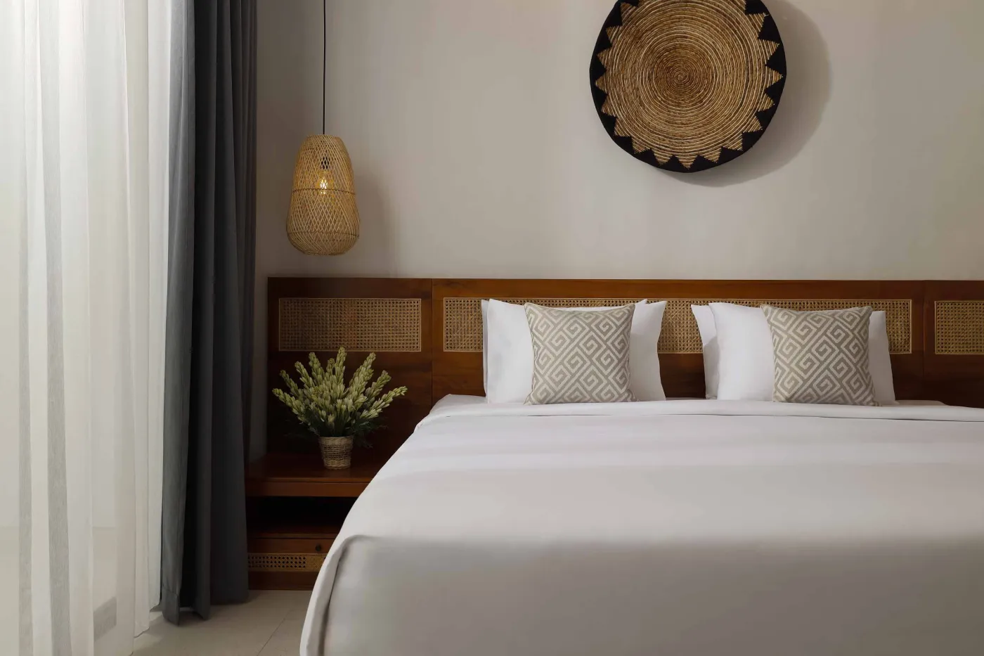 Modern open-plan kitchen and dining area with wooden furniture, tropical plants, and Balinese-style decor. - Bali Villas