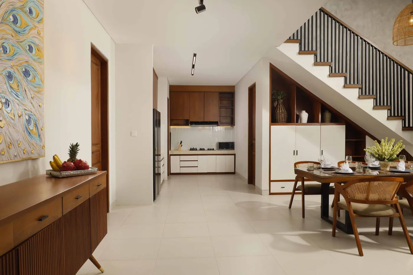 Modern open-plan kitchen and dining area with wooden furniture, tropical plants, and Balinese-style decor. - Bali Villas