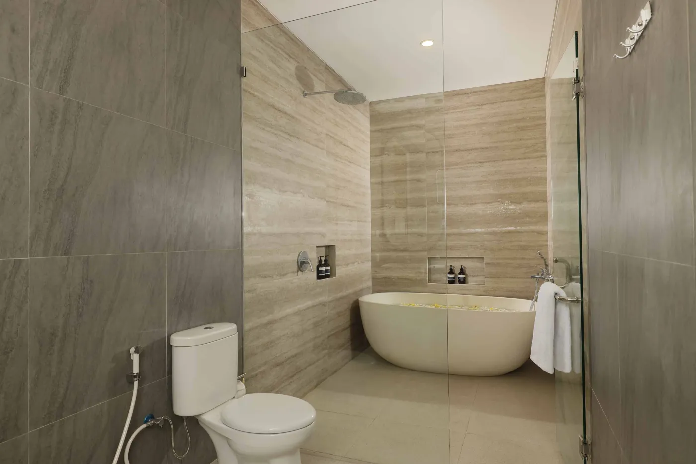 Modern open-plan kitchen and dining area with wooden furniture, tropical plants, and Balinese-style decor. - Bali Villas