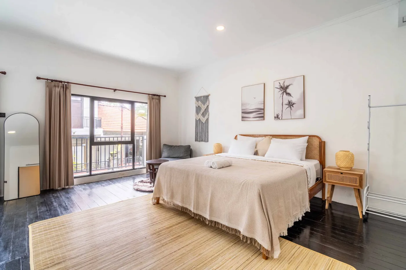 Modern white-tiled bathroom with glass shower enclosure, sink, and toilet. - Bali Villas