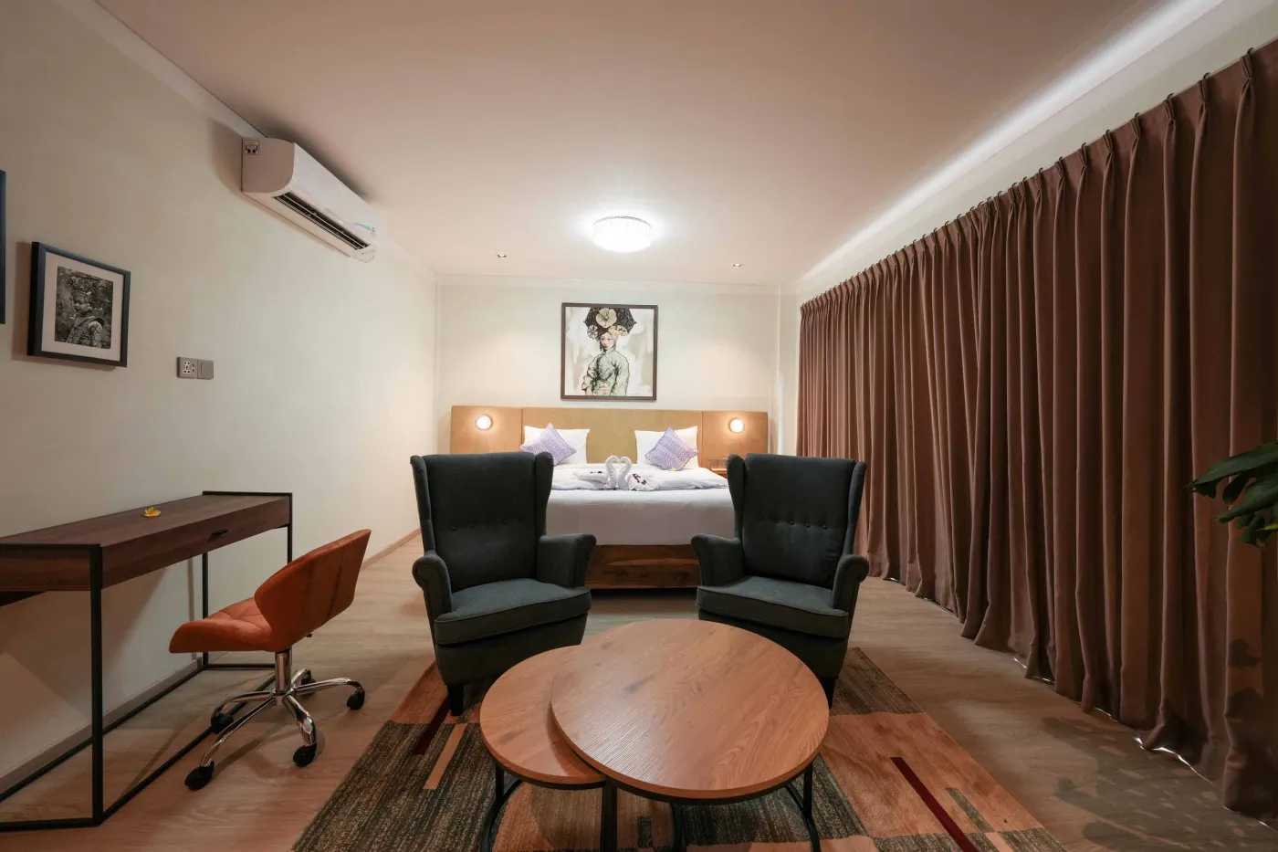 Modern wooden kitchen with stainless steel sink, refrigerator, microwave, cooktop, and warm LED lighting. - Bali Villas