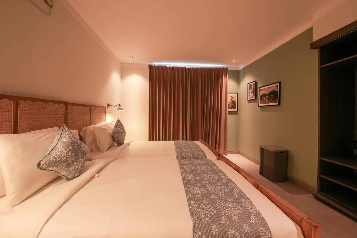 Modern wooden kitchen with stainless steel sink, refrigerator, microwave, cooktop, and warm LED lighting. - Bali Villas