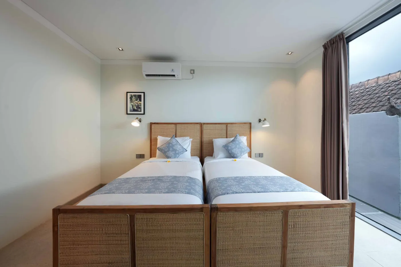 Modern wooden kitchen with stainless steel sink, refrigerator, microwave, cooktop, and warm LED lighting. - Bali Villas