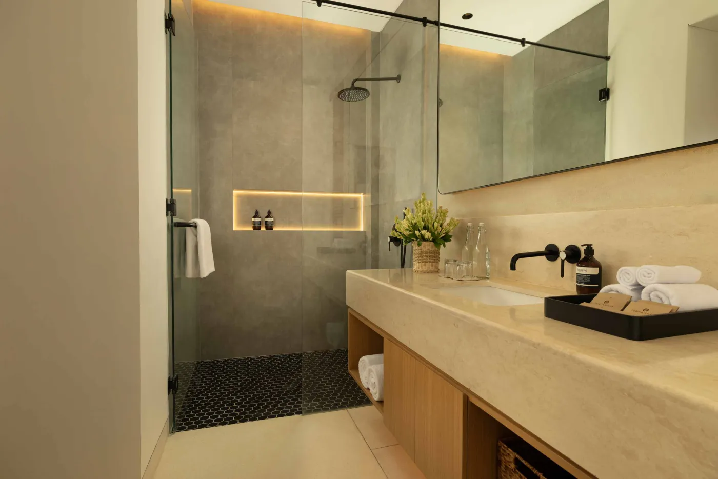 Modern game room featuring a sleek black pool table with red felt, surrounded by wooden stools, under a wooden ceiling with pendant lights, large windows showing tropical greenery, and stylish wooden accents. - Bali Villas