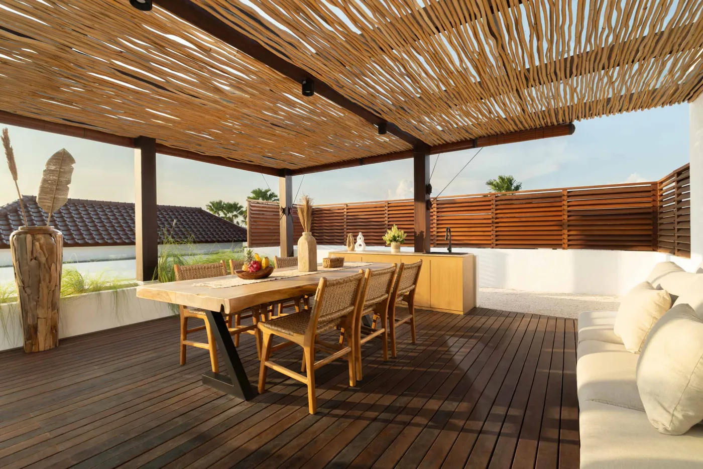 Modern game room featuring a sleek black pool table with red felt, surrounded by wooden stools, under a wooden ceiling with pendant lights, large windows showing tropical greenery, and stylish wooden accents. - Bali Villas