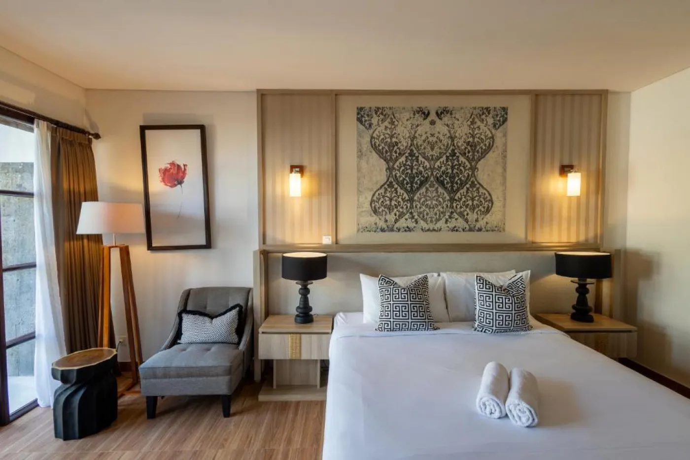 Modern en-suite bathroom featuring white vanity sink, glass shower enclosure, and adjacent mirrored wardrobe on beige tiled floor. - Bali Villas