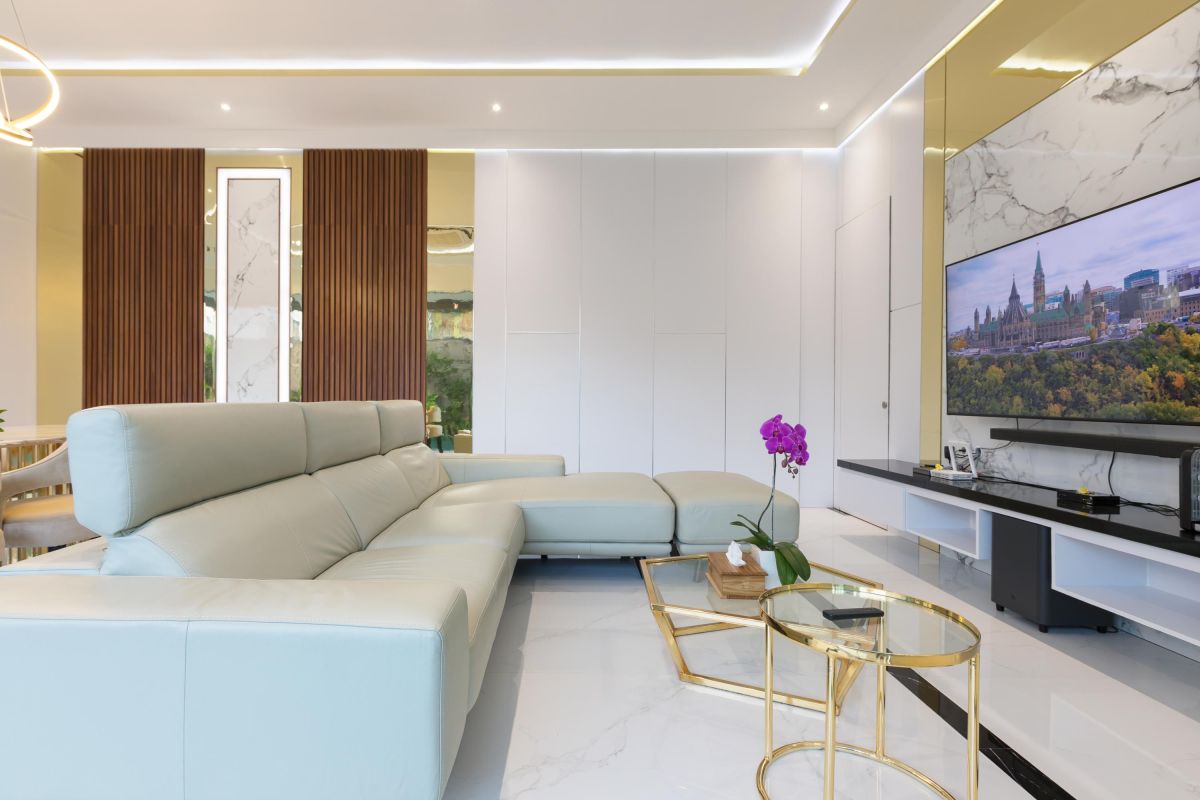 Modern luxury kitchen with glossy turquoise cabinets, marble counters, built-in appliances, and pendant lighting. - Bali Villas