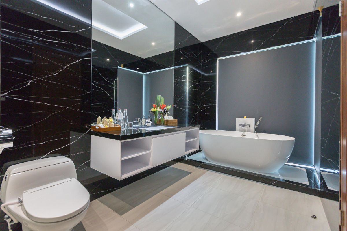 Modern luxury kitchen with glossy turquoise cabinets, marble counters, built-in appliances, and pendant lighting. - Bali Villas