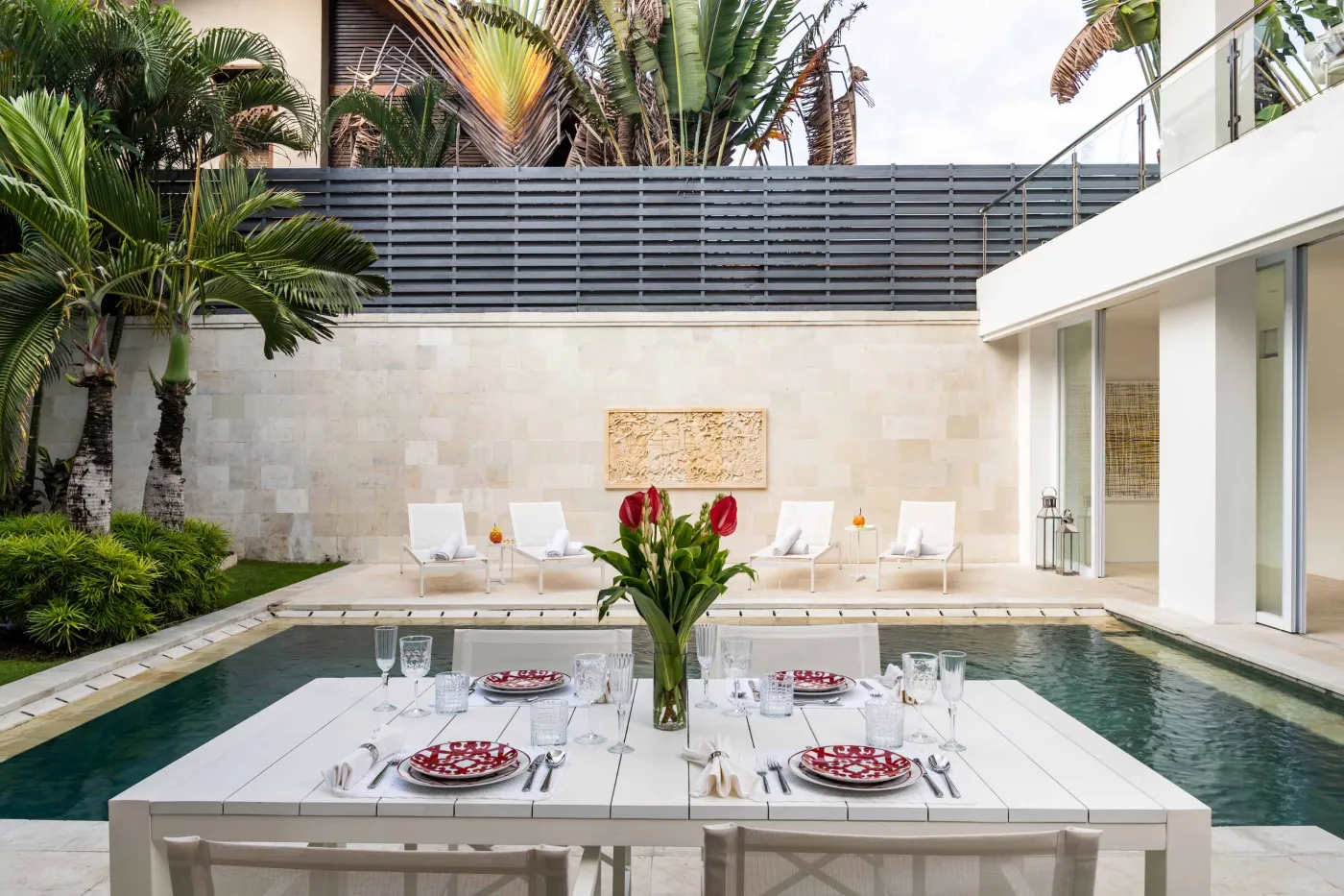 Modern home gym featuring a treadmill, weight bench, pull-up bars, exercise balls, and pink "Lifting" neon sign in a mirrored room. - Bali Villas