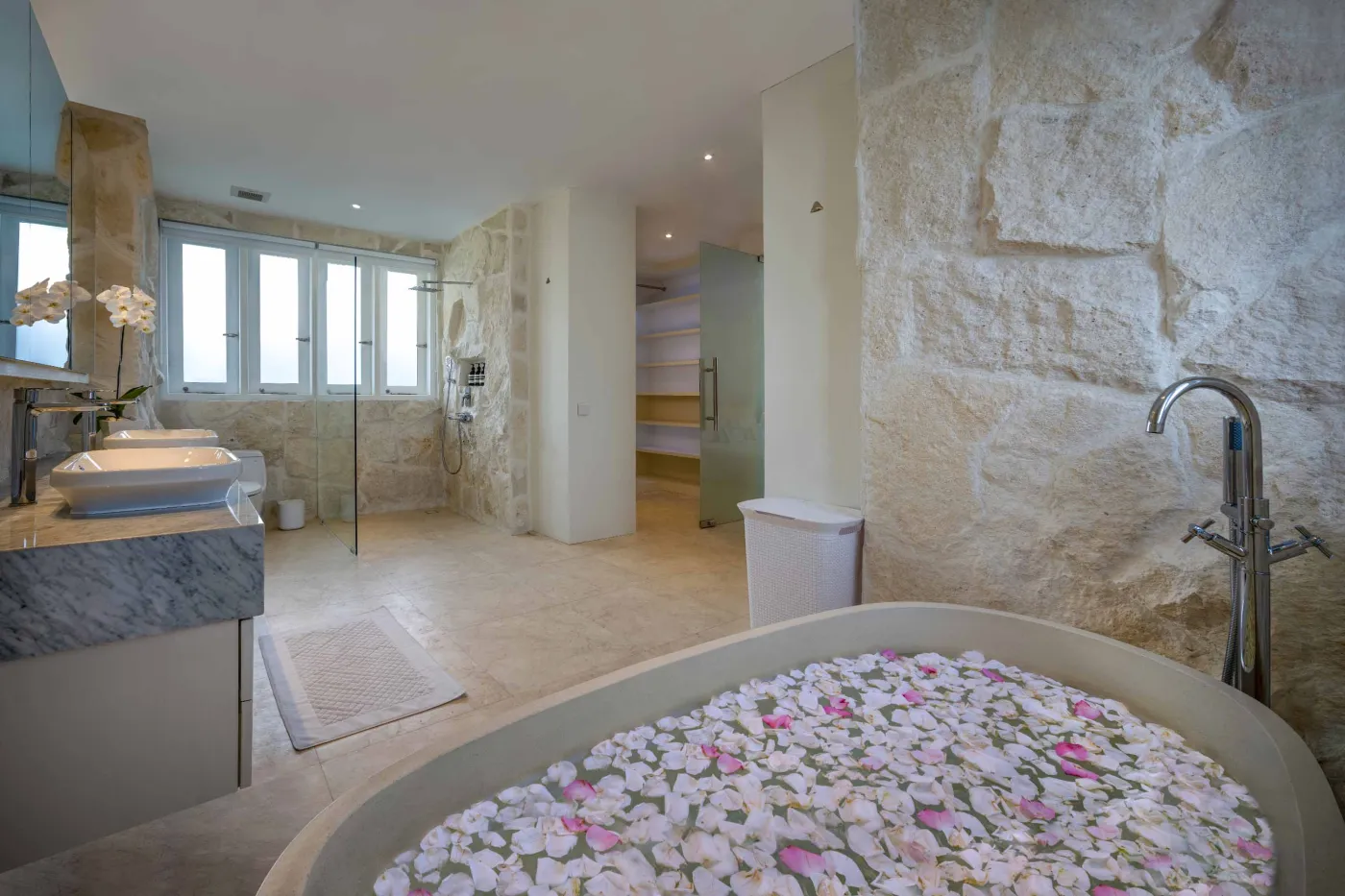 Modern home gym featuring a treadmill, weight bench, pull-up bars, exercise balls, and pink "Lifting" neon sign in a mirrored room. - Bali Villas
