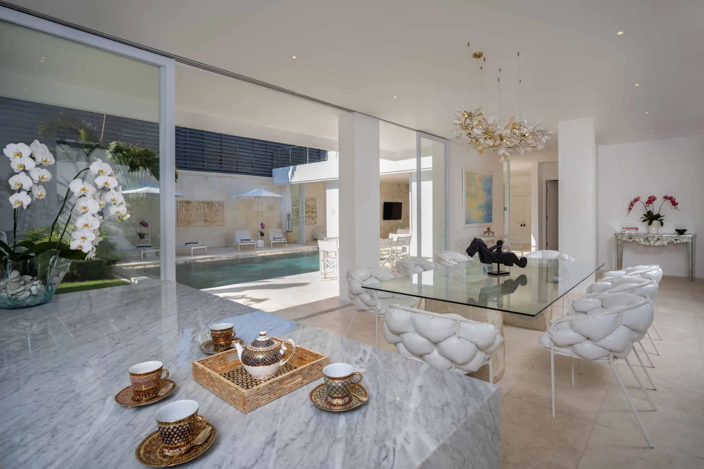 Modern home gym featuring a treadmill, weight bench, pull-up bars, exercise balls, and pink "Lifting" neon sign in a mirrored room. - Bali Villas
