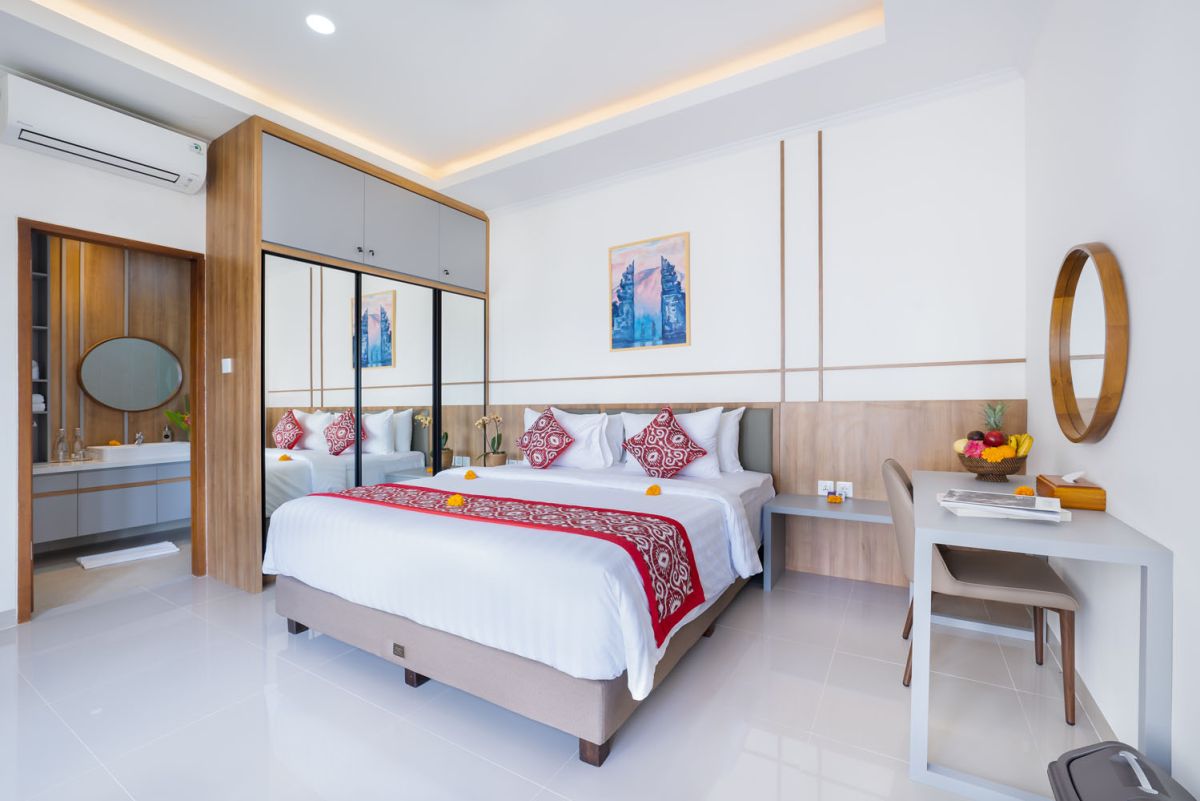 Spacious modern kitchen and dining area with wooden table set for meals, open cabinetry, and sliding glass doors to pool. - Bali Villas