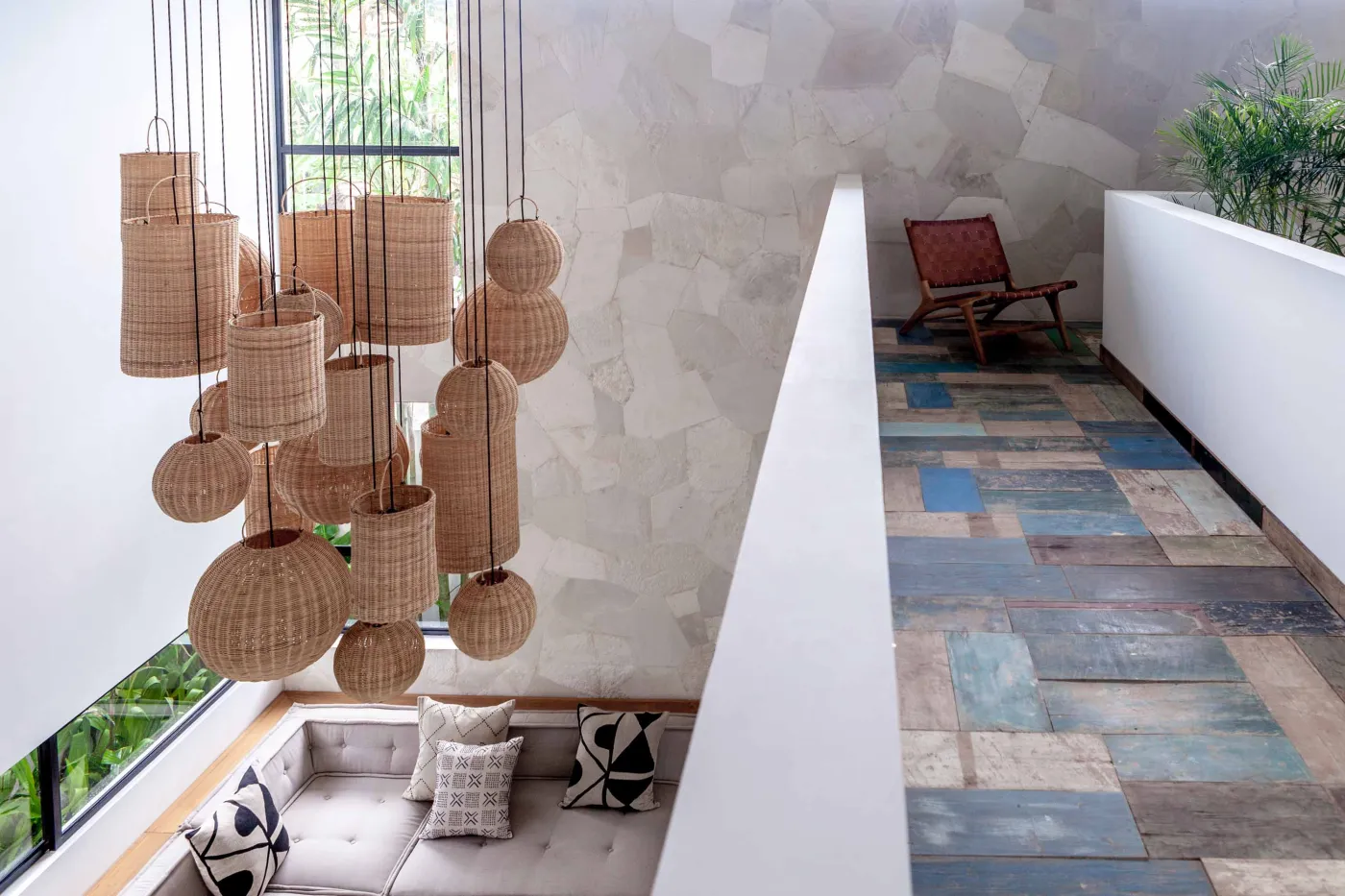 Spacious modern tropical kitchen and dining room with wooden table, rattan chairs, pendant lights, indoor plants, and large windows. - Bali Villas