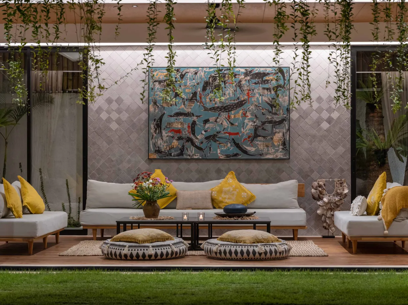 Luxurious open-air Balinese bathroom with freestanding bathtub filled with rose petals, wooden vanity, tropical plants, and geometric tiled floor. - Bali Villas