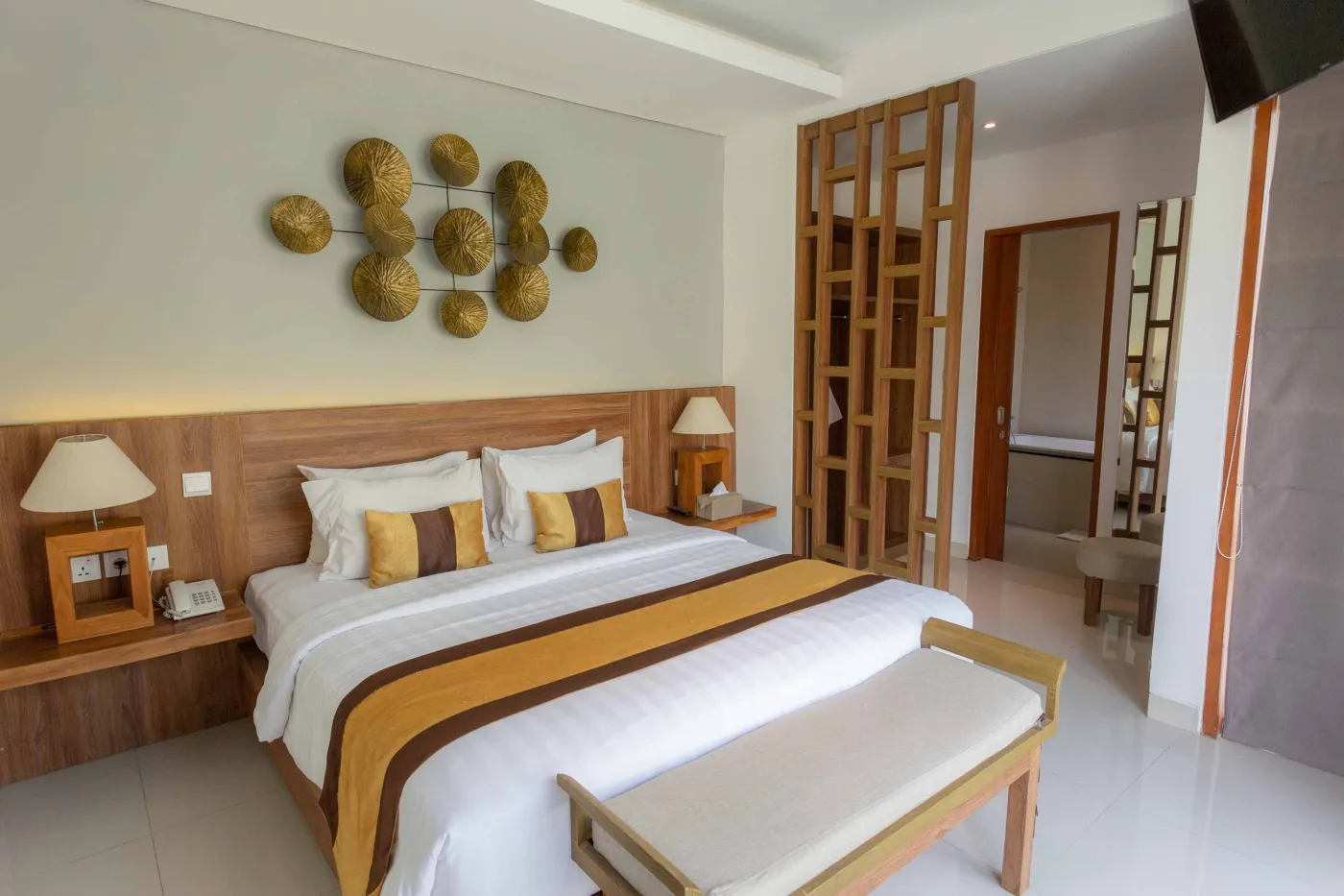 Luxurious tropical bedroom with king bed and sliding glass doors opening to a private plunge pool. - Bali Villas