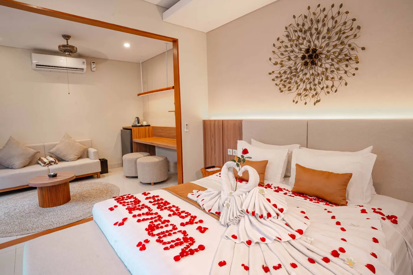 Luxurious Bali pool villa with private plunge pool, red bean bag chairs, and open doors to a rose petal-adorned bedroom. - Bali Villas