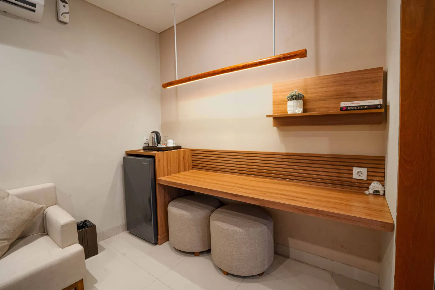 Luxurious Bali pool villa with private plunge pool, red bean bag chairs, and open doors to a rose petal-adorned bedroom. - Bali Villas