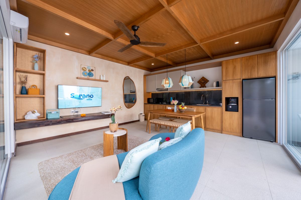 Modern luxury bathroom with soaking tub filled with water and lotus flowers, glass shower enclosure, tropical plants, and natural stone vanity. - Bali Villas