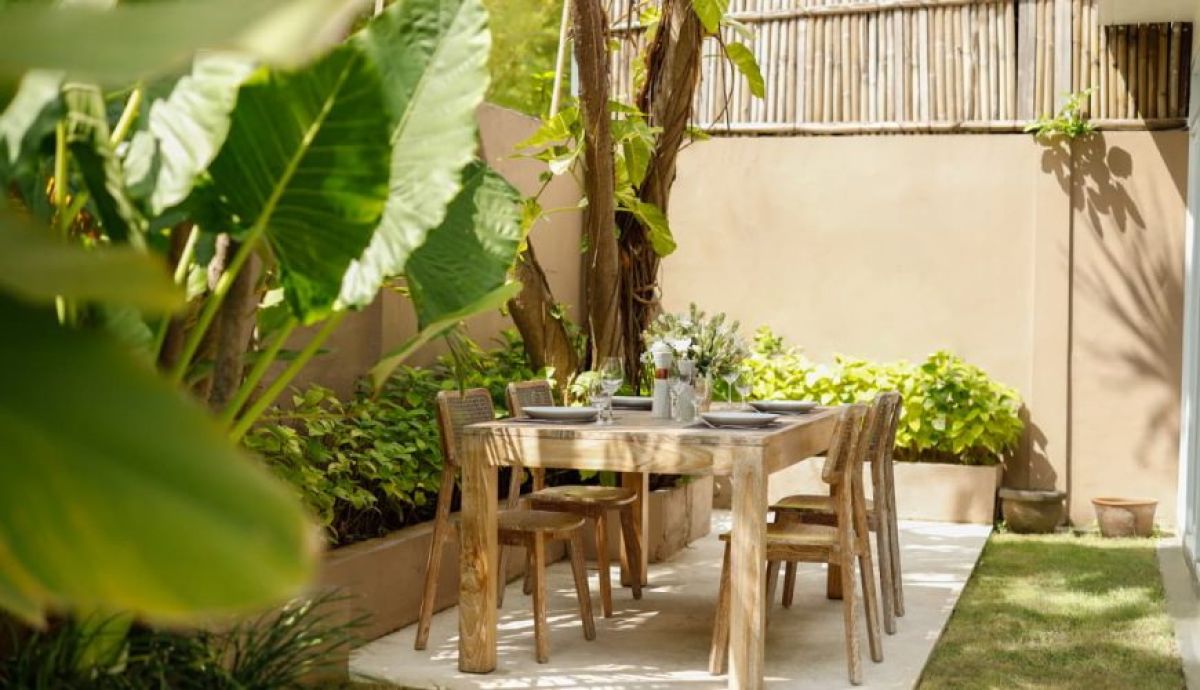 Modern Bali-style villa with infinity pool, lush tropical garden, white architecture, and sunny courtyard. - Bali Villas