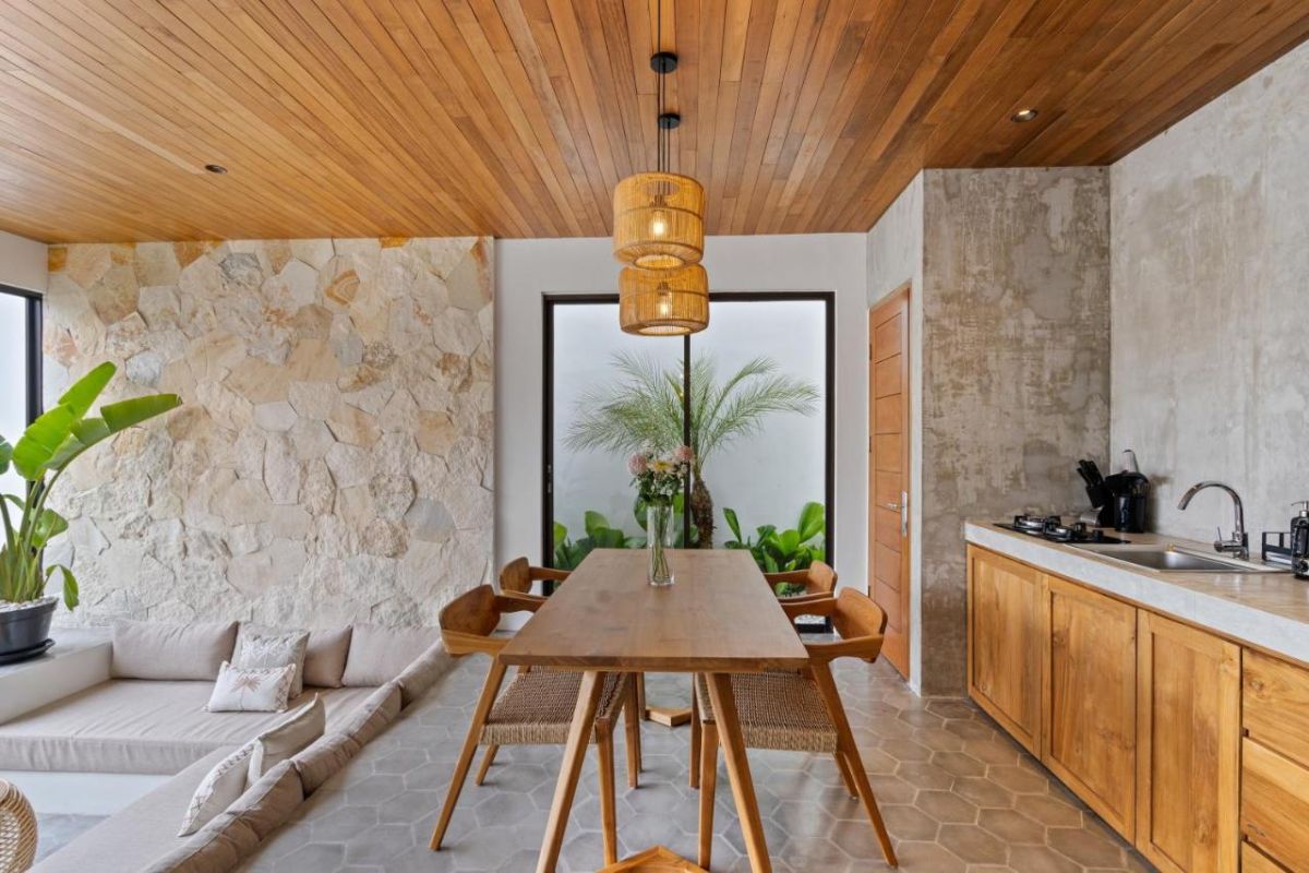 Serene modern bedroom with wooden bed, desk, and large windows overlooking lush green rice fields. - Bali Villas